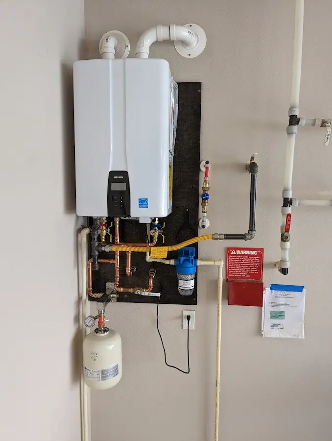 Professional plumber installing copper piping in a New Albany home